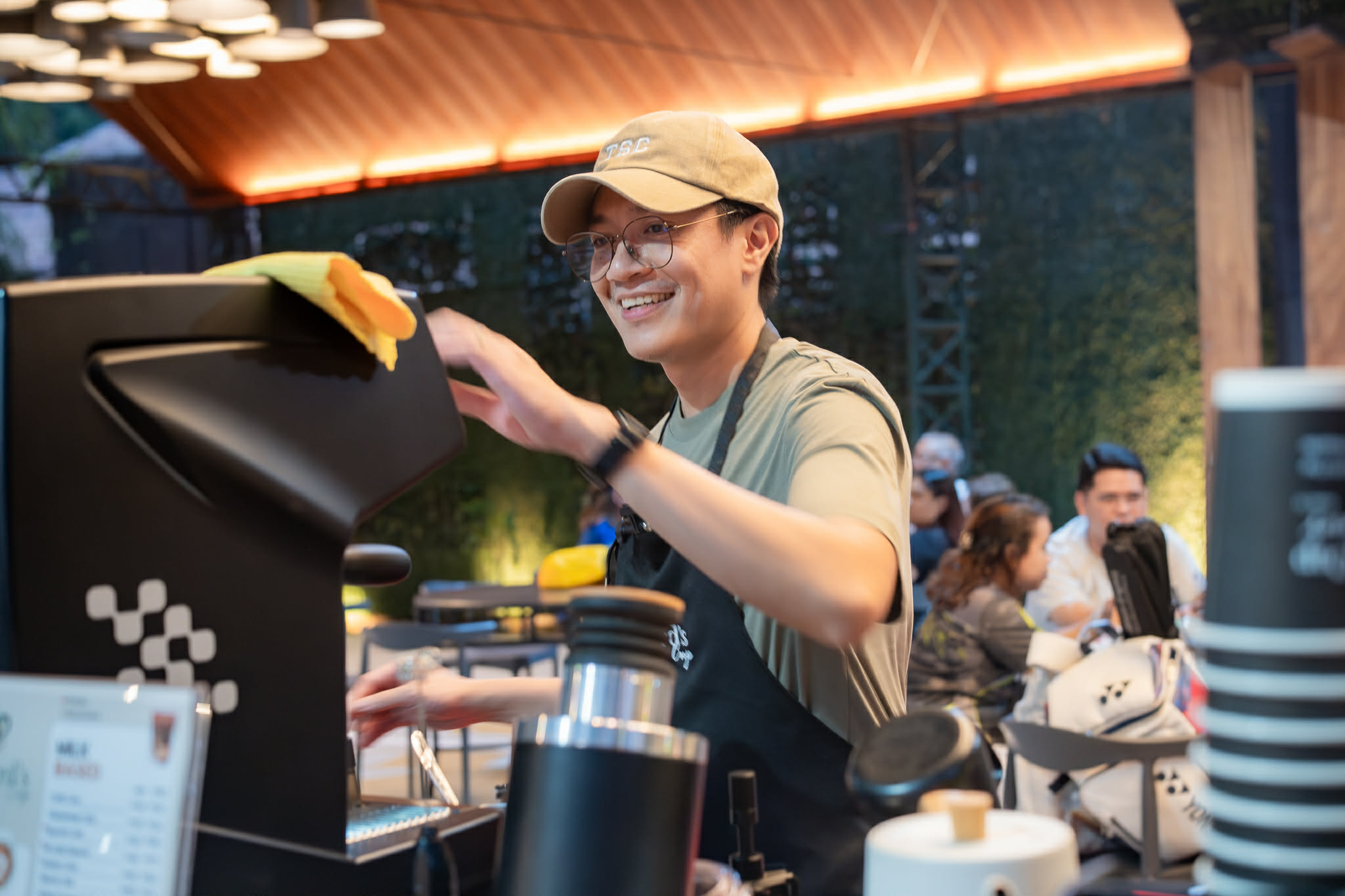 A Shepherd's Cup barista smiling while working the espresso bar