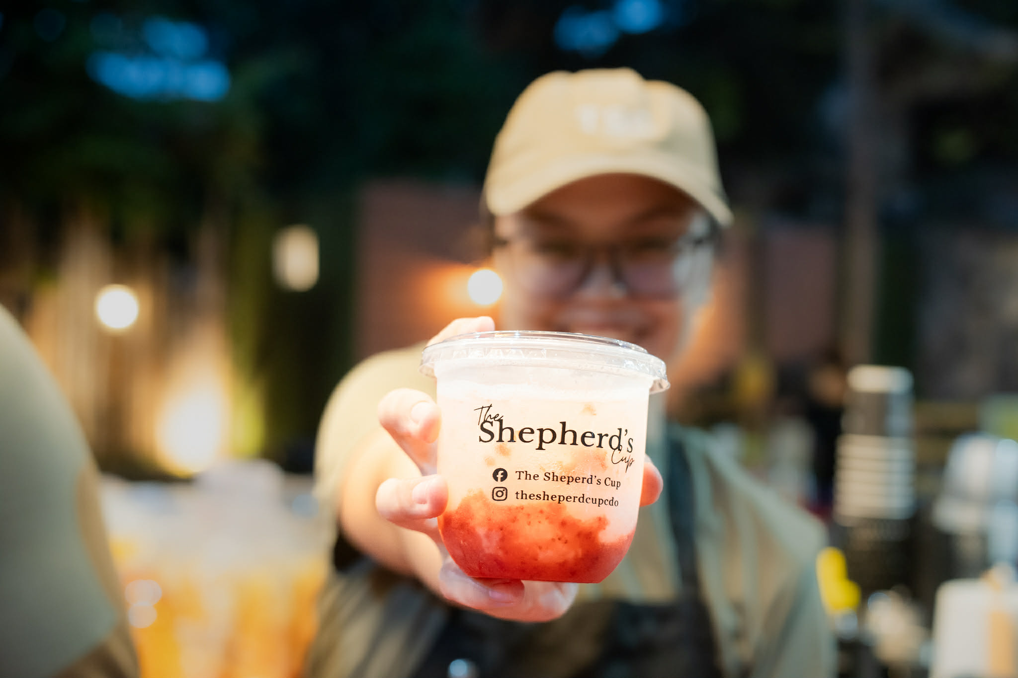 A wooden tray with three branded Shepherd's Cup drinks — Your Cup Overflows