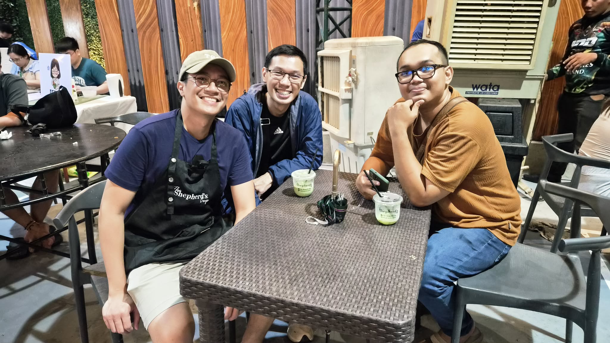 Three friends sharing matcha lattes from the Shepherd's Cup cart
